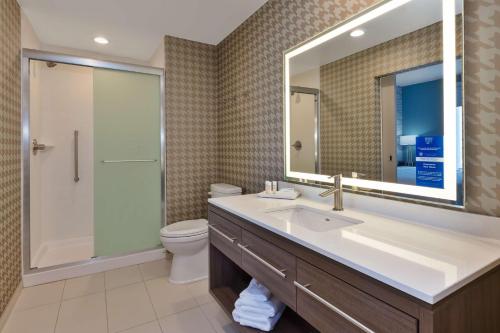 a bathroom with a sink and a toilet and a mirror at Home2 Suites By Hilton Tucson Airport, Az in Tucson