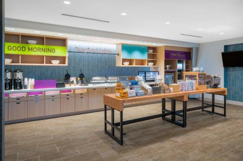 a kitchen with a counter with food on it at Home2 Suites By Hilton Brunswick in Brunswick