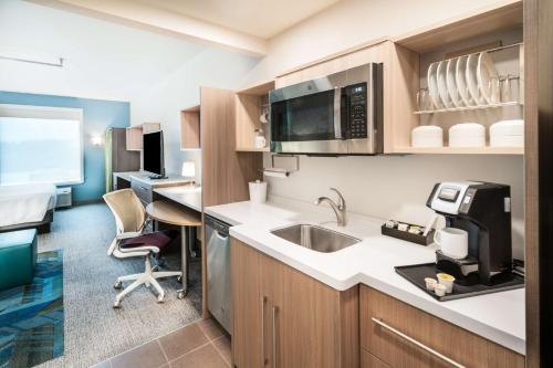 a kitchen with a sink and a desk at Home2 Suites By Hilton Brunswick in Brunswick