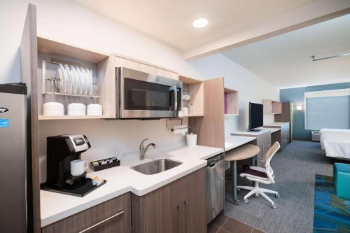 a kitchen with a sink and a desk in a room at Home2 Suites By Hilton Brunswick in Brunswick