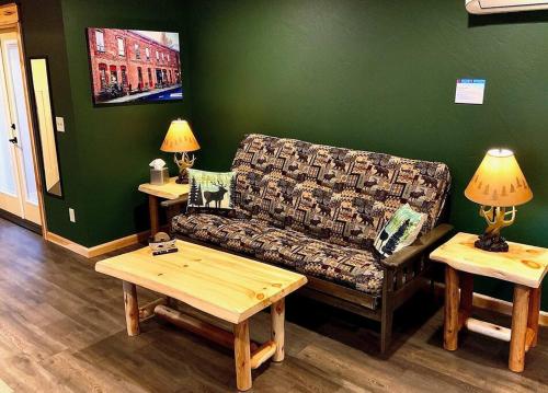 a living room with a couch and two tables at Cedar Mountain -Suite C in Grants Pass