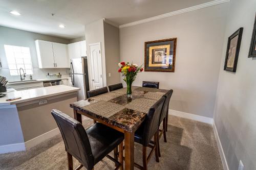 a kitchen and dining room with a table and chairs at Luxury Vacation Rentals by Meridian CondoResorts in Scottsdale