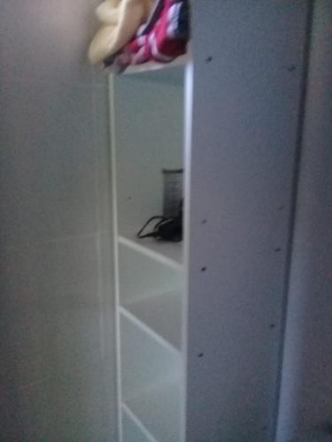 a mirror in a room with a closet with shelves at La rana alquiler temporal in Reyes