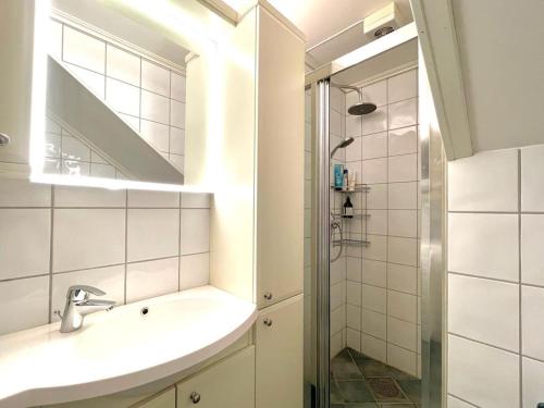 a bathroom with a sink and a shower at Venus Central apartment, Free Parking ! in Trondheim