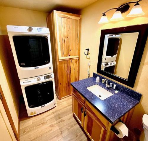 a kitchen with a stove and a sink and a microwave at Cedar Mountain Suite E in Grants Pass