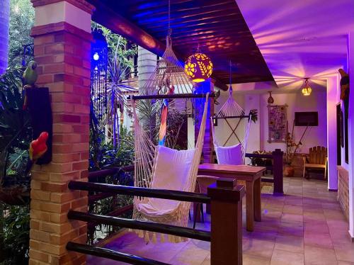 a porch with a hammock in a house with purple lighting at Camali Hotel in Santa Marta