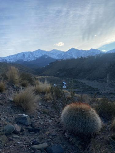 a view of a mountain with mountains in the background at Domos Andinos HostCamp in Potrerillos