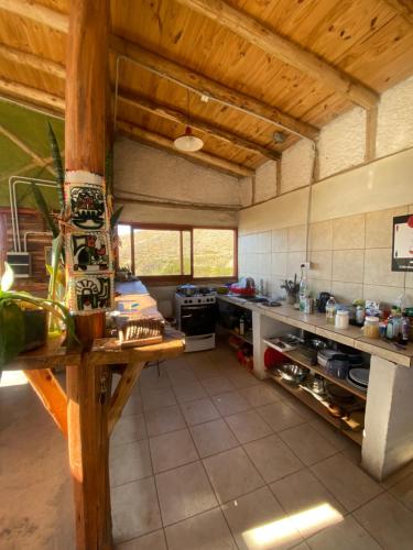 a large kitchen with a counter in a room at Domos Andinos HostCamp in Potrerillos