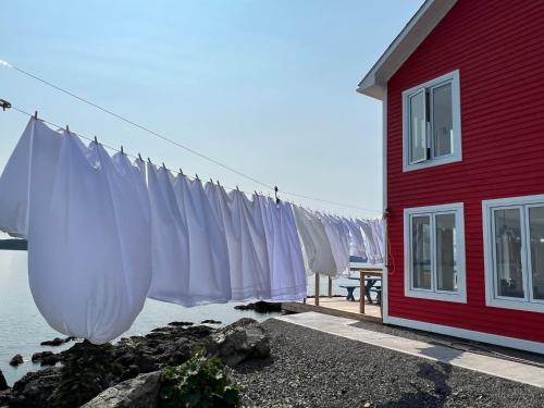 a clothes line is hanging outside of a red house at The View suites and breakfast in Triton, Newfoundland in Pilleyʼs Island