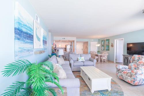 a living room with a couch and a table at St Regis 3406 in North Topsail Beach