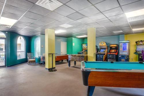 a room with a pool table and arcade games at St Regis 3406 in North Topsail Beach