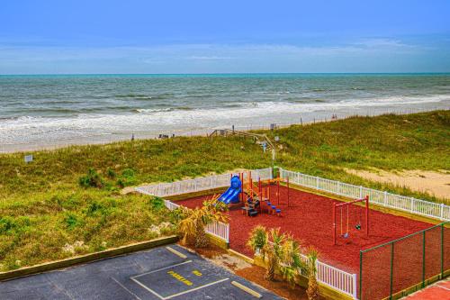 a playground on the beach with the ocean in the background at St Regis 3406 in North Topsail Beach