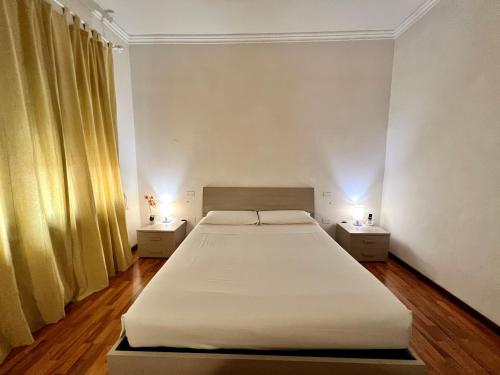 a bedroom with a large bed and two night stands at Venice Suites in Mestre