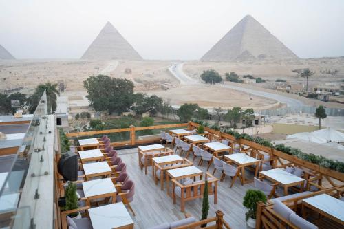 a view of the pyramids from the rooftop of a restaurant at Great Pyramid Inn in Cairo
