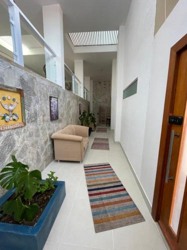 a hallway with a chair and a couch in a building at Espaço Nobre in Cunha