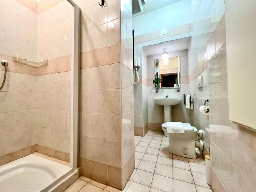 a bathroom with a shower and a toilet and a sink at Venice Suites in Mestre