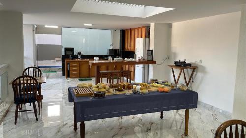 a table with food on it in a kitchen at Espaço Nobre in Cunha