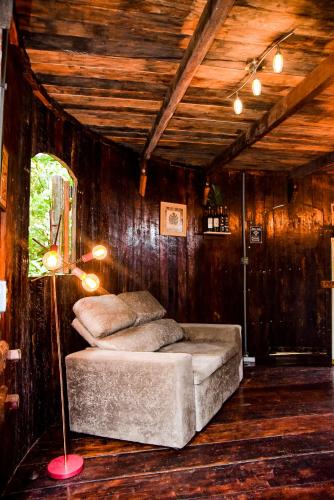 a bedroom with two beds in a room with wooden walls at Pipas de Araras - Cabernet in Petrópolis