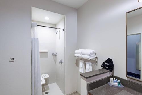 a bathroom with a shower and a sink at Fairfield Inn & Suites by Marriott Liberal in Liberal