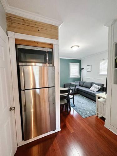 a kitchen and living room with a stainless steel refrigerator at Historic peaceful apartment in New Haven