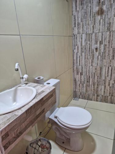 a bathroom with a toilet and a sink and a shower at Espaço Billynghan in Barreirinhas