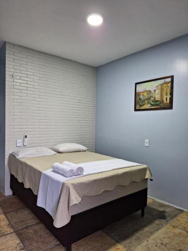 a bedroom with a large bed with towels on it at Espaço Billynghan in Barreirinhas