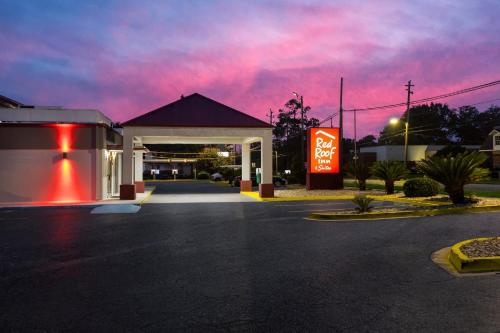 a gas station at night with a red sky at Red Roof Inn & Suites Statesboro - University in Statesboro