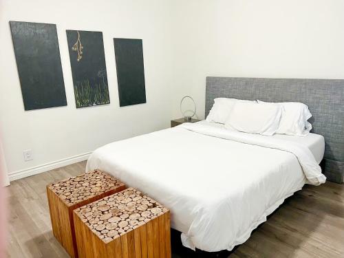 a bedroom with a large bed and two paintings on the wall at Century City Condo by Westfields in Los Angeles