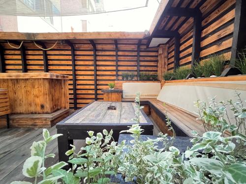 a wooden patio with a table and some plants at Varna Cathedral Apartments in Varna City