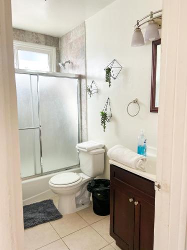 a bathroom with a shower and a toilet and a sink at Charming Century City Condo in Los Angeles