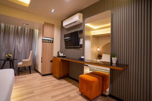 a hotel room with a bed and a desk with a television at Great Pyramid Inn in Cairo