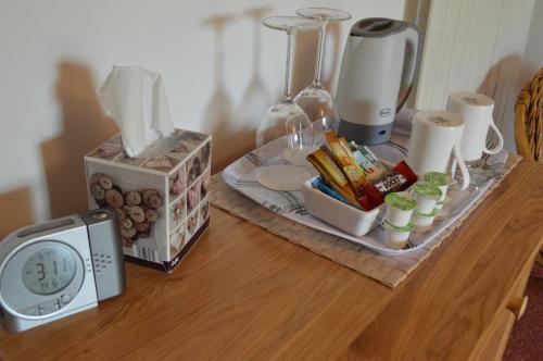 a table with a counter top with food and a clock at Troedyrhiw Bed & Breakfast in Cardigan