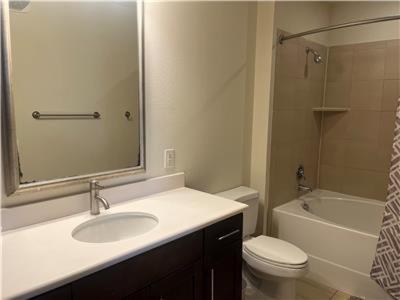 a bathroom with a sink and a toilet and a mirror at Gorgeous Furnished Apartments near Texas Medical Center & NRG Stadium in Houston