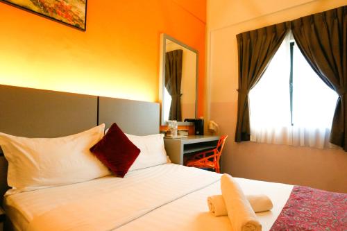 Postel nebo postele na pokoji v ubytování Travelland Hotel