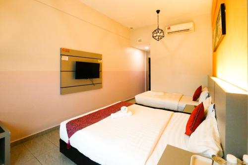 Postel nebo postele na pokoji v ubytování Travelland Hotel