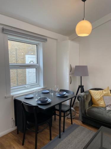 a living room with a table and a couch at 4Bed Loft Style Apartment With PrivateTerrace in London