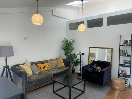 a living room with a couch and a chair at 4Bed Loft Style Apartment With PrivateTerrace in London
