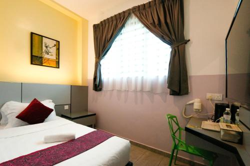 Postel nebo postele na pokoji v ubytování Travelland Hotel