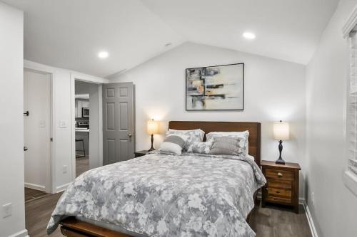 a white bedroom with a large bed and two lamps at Spacious & Charming House in Heart of Atlanta in Atlanta