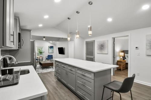 a kitchen with a white counter and a dining room at Spacious & Charming House in Heart of Atlanta in Atlanta