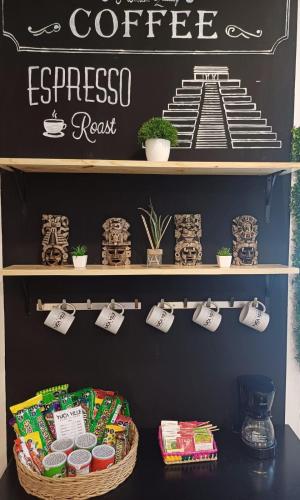 a shelf with a coffee espressoresist sign on a wall at Hotel & Suites Yuca Ville Siglo XXI in Mérida