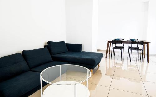a living room with a couch and a table at Encorp Strand Residences by Airhost in Kota Damansara