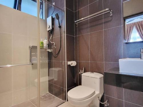 a bathroom with a toilet and a glass shower at D'Secret Tropika - 2 Bedrooms 4 Pax, Free Parking in Johor Bahru