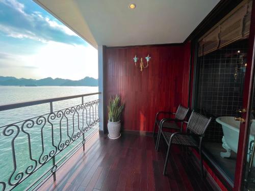 a bathroom with a balcony with a tub and a view of the water at Indochine Premium Halong Bay in Ha Long