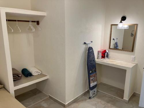 a bathroom with a sink and a mirror at Los Amores Apartments A in Pérula