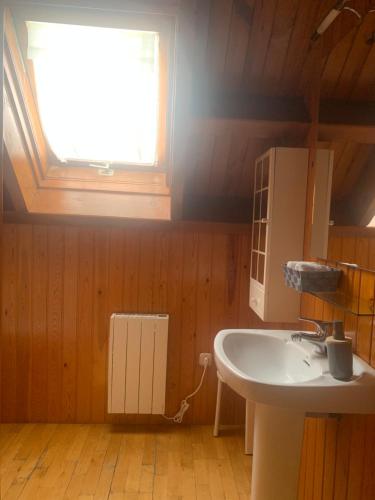 a bathroom with a sink and a window at Allotjament SV in Pla de l'Ermita