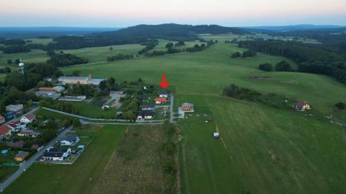 an aerial view of a small town in a green field at Apartmány Kohoutek a Slepička v Novohradských horách in Nové Hrady