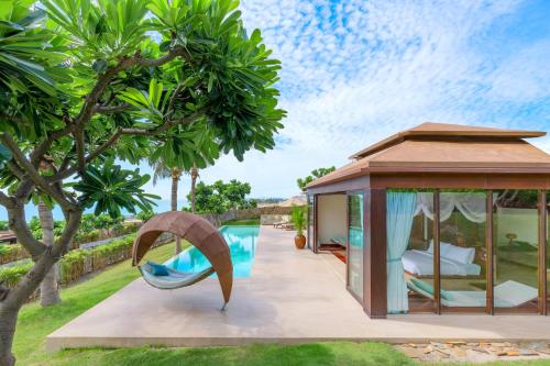 a house with a pool and a gazebo at Fusion Resort Cam Ranh - All Spa Inclusive in Cam Ranh