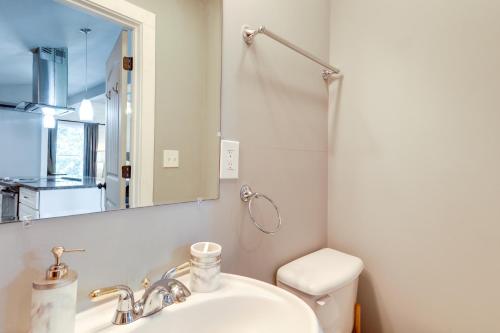 a bathroom with a sink and a toilet and a mirror at Atlanta Vacation Rental 9 Mi to Downtown! in Atlanta