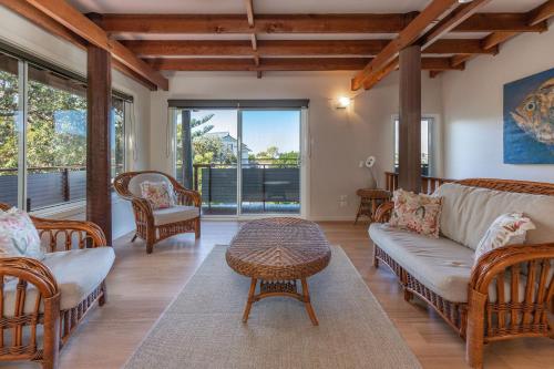 a living room with a couch and chairs and a table at The Pole House in Elizabeth Beach